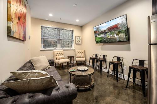a living room with a couch and a table and chairs at The West End Flats Hotel in Roanoke