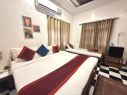 a bedroom with two beds and a window at RnB Beach Resort in Anjuna