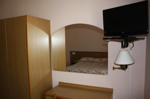 Ένα ή περισσότερα κρεβάτια σε δωμάτιο στο Hotel Vapore