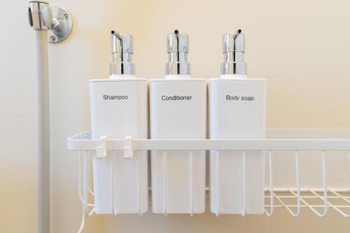 a group of three white heaters on a shelf at Coto House Kamakura RoomB in Kamakura