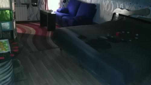 a bedroom with a bed and a chair and a couch at Anahuaska Art - Suites Temáticas in Panzares