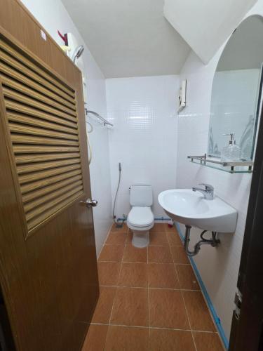 a bathroom with a toilet and a sink at Toul Sleng Double Room in Phnom Penh