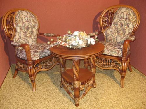two chairs and a table with a bowl of flowers on it at Hotel Complex Zelenyi Gai in Kopachuvka