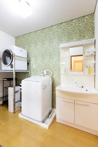 a bathroom with a sink and a mirror at gently stay Nagoya in Nagoya