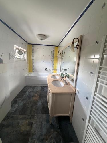 a bathroom with a sink and a tub at Apartments Nicole in Baden