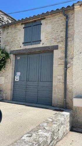 a pair of garage doors on a stone building at chemin de compostelle in Montcuq
