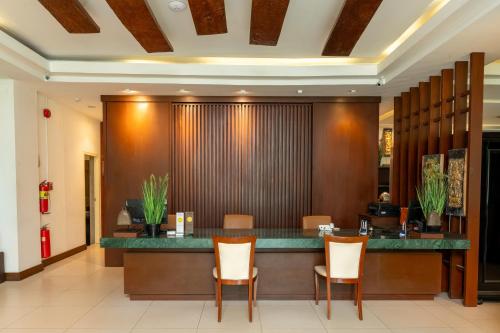 a lobby with a reception desk and chairs at City Inn Vientiane in Vientiane