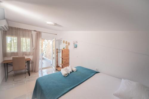 a bedroom with a bed with two towels on it at Aegean View Summer House 1 in Nea Kallikrateia