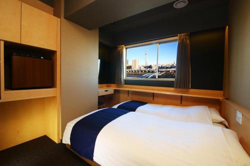 Tempat tidur dalam kamar di Hotel Wing International Select Asakusa Komagata