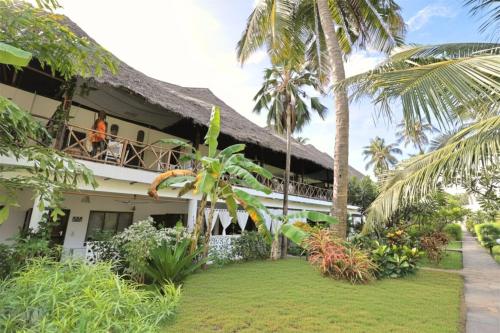 a resort with people on the balcony of it at Watamu Ascot Residence in Watamu