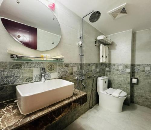 a bathroom with a sink and a shower and a toilet at Sea Paradise in Cox's Bazar