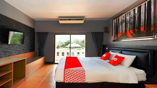 a bedroom with a large bed with red pillows at Blue Horizon in Hua Hin