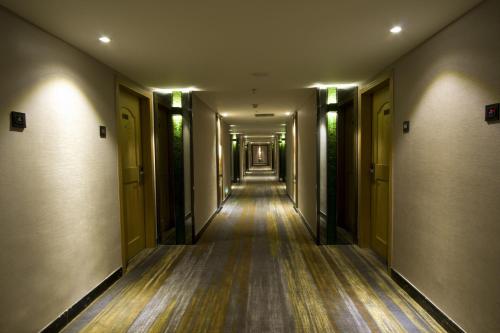an empty hallway with a long corridor at Shenzhen Kaili Hotel, Guomao Shopping Mall in Shenzhen