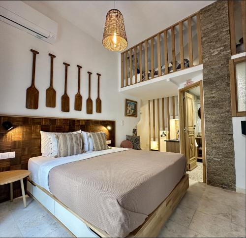 a bedroom with a large bed and a staircase at Avra Guesthouse in Limenas