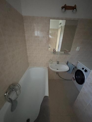 a bathroom with a white tub and a sink at Bogi House in Balatonfüred