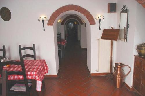 a room with a table and a hallway with an archway at Hotel Astoria in Satu Mare
