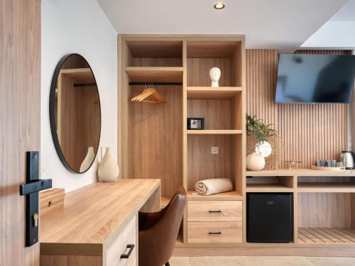 a room with a desk with a tv and a mirror at Starlight Ocean View in Kardamaina