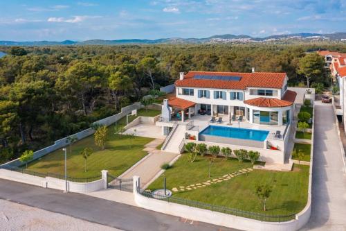 Luxury villa Sea Whisper steps from beach with indoor & outdoor pools near Šibenik