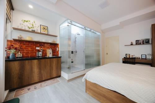 a bedroom with a glass shower and a bed at Anchie Hanoi House in Hanoi