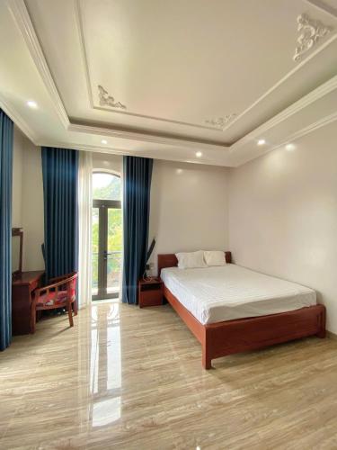 a large bedroom with a bed and a window at Thành Đạt Homestay Cát Bà in Cat Ba