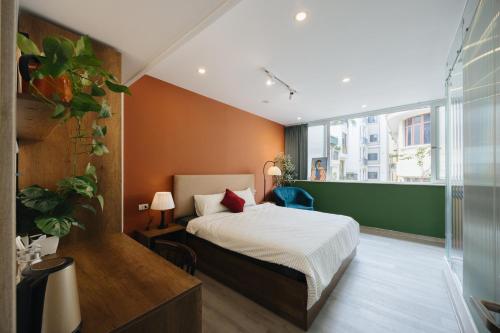 a bedroom with a bed and a large window at Anchie Hanoi House in Hanoi