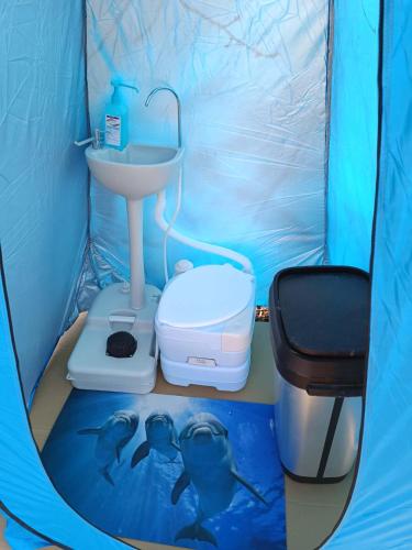 a bathroom with a sink and two dolphins in a tent at Baťův kanál Babice1 glamping in Babice