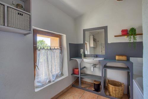 a bathroom with a sink and a mirror at L'Instant Cabanon, 349 chemin des Maridats in Bédoin
