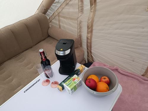 a coffee maker and a bowl of fruit on a table at Baťův kanál Babice1 glamping in Babice