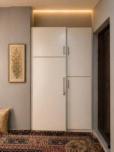 a large white refrigerator in a room with a rug at SH Valley Homestay in Srinagar
