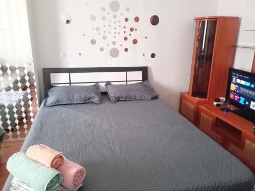 a bedroom with a bed with two towels on it at Абай2 169 in Astana