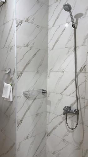 a bathroom with a shower with a glass door at Airport sky in Amman