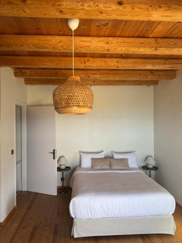 a bedroom with a large bed with a wooden ceiling at VillaAurora-mani in Areopoli