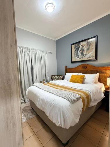 a bedroom with a large bed in a room at The Well Apartments in Mbabane