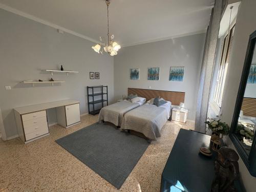a bedroom with a bed and a desk in it at Casa Acqua e Sale - 50 mt dal mare in Fano