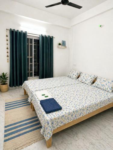 a bedroom with a bed in a room at The Travellers Nest in Siliguri