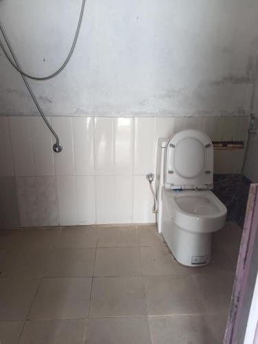 a bathroom with a toilet with the lid up at Saura place Homestay in Nagarkot