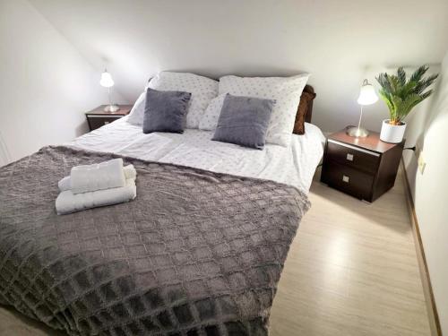 a bedroom with a large bed with two night stands at Diament Rogowo in Rogowo