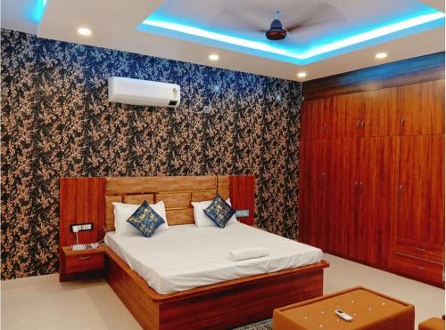 a bedroom with a bed with a blue ceiling at Hotel Grand Radhe Krishna inn in Vrindāvan