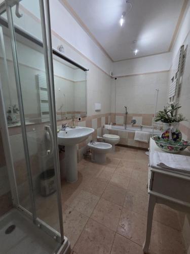 a bathroom with two toilets and a sink and a shower at Queen Apartment - Stunning Panoramic Island View in Baveno