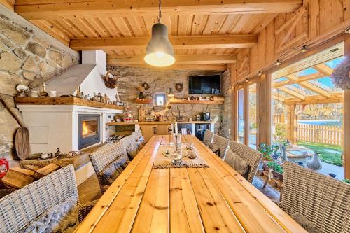a dining room with a wooden table and chairs at Wellness & Golf Chaloupka Ovčárna in Nová Bystřice