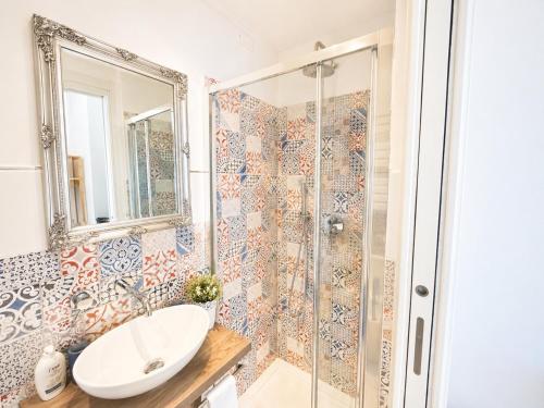 a bathroom with a sink and a shower at Vertigini Suites, Il Rifugio dell Amore per SOLE COPPIE , A 50m dalla Stazione e dalla Via dell Amore con Vista Mare e Intimità Appagante in Riomaggiore