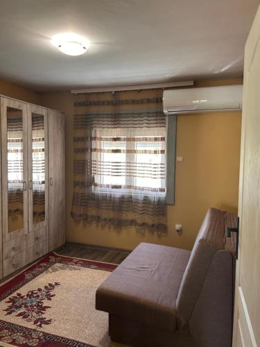 a living room with a couch and a window at Vikendica Aurora in Šabac