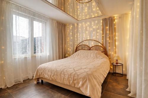 a bedroom with a bed and a window at L'Ecrin des Monts in Bailleul