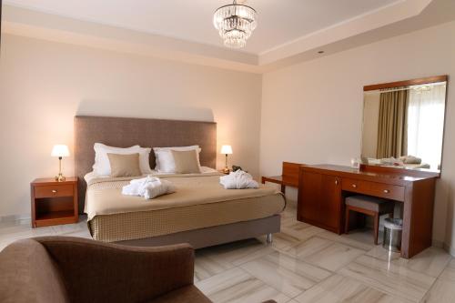 a hotel room with a bed and a desk and a desk at Nefeli Hotel in Alexandroupoli