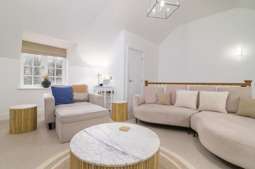 a living room with two couches and a table at Sandsend Retreats at Saltmoore in Sandsend