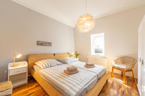 a bedroom with a bed with two towels on it at Captains Haven in Eckernförde