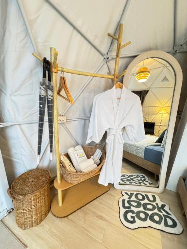 a room with a tent with a bed and a mirror at Khao Poon Camping in Kanchanaburi City