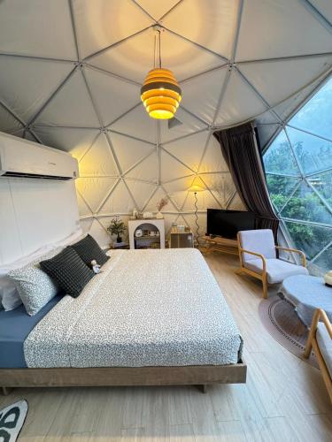 a bedroom with a bed in a tent at Khao Poon Camping in Kanchanaburi City