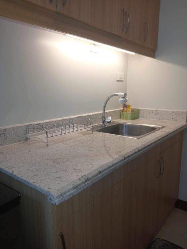a kitchen counter with a sink and a light at Verdon Parc Butterfly Haven in Davao City