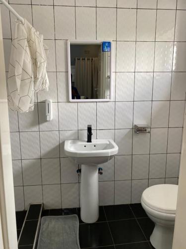 a bathroom with a sink and a toilet at The Stone Duplex Apartment House 1 in Lilongwe